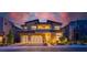 Beautiful two-story home showcasing manicured landscaping, stone accents, and a spacious three-car garage at dusk at 10748 Steel Ridge Ct, Las Vegas, NV 89135