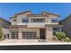 Stunning two-story home with a neutral color palette, three-car garage and manicured front yard at 10748 Steel Ridge Ct, Las Vegas, NV 89135