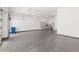 Spacious garage with epoxy flooring and ample storage, providing a clean and organized space for vehicles and hobbies at 10748 Steel Ridge Ct, Las Vegas, NV 89135