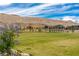 A large community green space abuts neighborhood homes and desert landscaping at 10748 Steel Ridge Ct, Las Vegas, NV 89135
