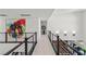 Bright upstairs hallway featuring modern railings and decorative wall art at 10748 Steel Ridge Ct, Las Vegas, NV 89135