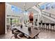 Spacious living room boasts soaring ceilings, sleek staircase, and access to outdoor living area at 10748 Steel Ridge Ct, Las Vegas, NV 89135