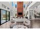 Stylish living room boasting soaring ceilings, clerestory windows, fireplace, and an adjacent staircase and bar at 10748 Steel Ridge Ct, Las Vegas, NV 89135