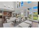 Bright, open-concept living area with contemporary furniture and large windows showcasing the backyard at 10748 Steel Ridge Ct, Las Vegas, NV 89135