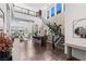Bright, open living room with a staircase, modern decor, high ceilings, and large windows offering backyard views at 10748 Steel Ridge Ct, Las Vegas, NV 89135