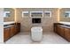 Spa-like bathroom featuring a freestanding tub, stone accent wall, and dual vanities for luxurious relaxation at 10748 Steel Ridge Ct, Las Vegas, NV 89135