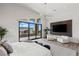 Spacious main bedroom with balcony, sleek lighting, and stylish accent wall at 10748 Steel Ridge Ct, Las Vegas, NV 89135