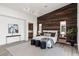 Cozy main bedroom with wood accent wall, modern furnishings, and an elegant feel at 10748 Steel Ridge Ct, Las Vegas, NV 89135