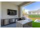 Outdoor kitchen featuring granite countertop, stainless steel grill and refrigerator, perfect for alfresco dining at 10748 Steel Ridge Ct, Las Vegas, NV 89135