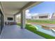 Outdoor patio with a built-in grill, outdoor kitchen, and view of the backyard pool at 10748 Steel Ridge Ct, Las Vegas, NV 89135