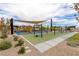 Community playground featuring shade structure and several different pieces of play equipment at 10748 Steel Ridge Ct, Las Vegas, NV 89135