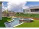 Sparkling pool and spa surrounded by lush artificial turf, offering a private oasis for relaxation and recreation at 10748 Steel Ridge Ct, Las Vegas, NV 89135