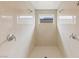 Inviting walk-in shower featuring dual shower heads, white tiled walls, and a window for natural light at 10748 Steel Ridge Ct, Las Vegas, NV 89135