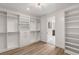 Well-lit walk-in closet with custom shelving, drawers, and rods offering ample storage space and convenience at 10748 Steel Ridge Ct, Las Vegas, NV 89135
