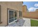 Private backyard with brick pavers, artificial turf, and secure fencing at 10974 Cheshire Woods Ave, Las Vegas, NV 89166