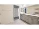 Bathroom featuring double sinks, granite countertops, and neutral cabinetry at 10974 Cheshire Woods Ave, Las Vegas, NV 89166