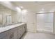 Bathroom featuring dual sinks and walk-in shower at 10974 Cheshire Woods Ave, Las Vegas, NV 89166