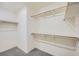 Walk-in closet with built in shelving units at 10974 Cheshire Woods Ave, Las Vegas, NV 89166