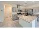 Modern kitchen with stainless steel appliances, granite countertops, and an island with a sink at 10974 Cheshire Woods Ave, Las Vegas, NV 89166