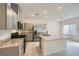 Modern kitchen with stainless steel appliances, granite countertops, and an island with a sink at 10974 Cheshire Woods Ave, Las Vegas, NV 89166