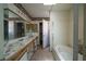 Full bathroom featuring a double sink, bathtub, and neutral tiling at 1436 Padre Bay Dr, Las Vegas, NV 89108