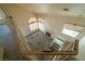 View of the living room from the top of the stairs, with a fireplace and multiple windows at 1436 Padre Bay Dr, Las Vegas, NV 89108