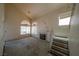 Spacious living room with a fireplace, a vaulted ceiling and access to the staircase at 1436 Padre Bay Dr, Las Vegas, NV 89108