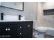 Bathroom with a black vanity, gold hardware and marble tiled shower at 1440 Vegas Valley Dr # 3, Las Vegas, NV 89169