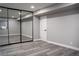 Bright bedroom with gray walls, wood-look floors, and mirrored closet doors at 1440 Vegas Valley Dr # 3, Las Vegas, NV 89169