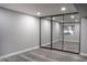 Bright bedroom with gray walls, wood-look floors, and mirrored closet doors at 1440 Vegas Valley Dr # 3, Las Vegas, NV 89169