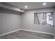 Bedroom with gray walls, a window, base molding, and gray wood-look floors at 1440 Vegas Valley Dr # 3, Las Vegas, NV 89169