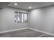 Bedroom with gray walls, a window, base molding, and gray wood-look floors at 1440 Vegas Valley Dr # 3, Las Vegas, NV 89169