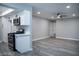 The kitchen has white cabinets, stainless appliances, gray walls, and gray wood-look floors at 1440 Vegas Valley Dr # 3, Las Vegas, NV 89169