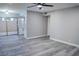 Open living room with wood-look floors, white trim, and a ceiling fan at 1440 Vegas Valley Dr # 3, Las Vegas, NV 89169