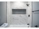 Bathroom shower showcasing marble tile, matte black hardware and a built in shelf at 1440 Vegas Valley Dr # 3, Las Vegas, NV 89169