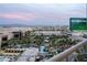 Luxurious rooftop pool with palm trees and views of the surrounding city and mountains at 145 E Harmon Ave # 1120, Las Vegas, NV 89109