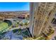 Stunning aerial view of the community featuring a golf course, pool area, and high-rise buildings with mountain backdrop at 145 E Harmon Ave # 1120, Las Vegas, NV 89109
