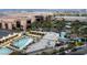 Expansive rooftop pool area featuring palm trees, cabanas, and views of the cityscape at 145 E Harmon Ave # 1120, Las Vegas, NV 89109