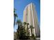 Exterior view of a modern condo high-rise building in Las Vegas with palm trees at 145 E Harmon Ave # 1120, Las Vegas, NV 89109
