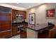 Compact kitchen with wooden cabinets, stainless steel appliances, and granite countertop bar at 145 E Harmon Ave # 1120, Las Vegas, NV 89109