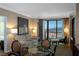 Well-lit living room with a comfortable couch and a large window with a view at 145 E Harmon Ave # 1120, Las Vegas, NV 89109
