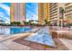 Resort-style pool with clear blue water, lounge chairs, and lush landscaping at 145 E Harmon Ave # 1120, Las Vegas, NV 89109