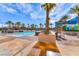 Serene pool area with tropical plants and inviting lounge chairs for relaxing by the water at 145 E Harmon Ave # 1120, Las Vegas, NV 89109