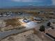 Aerial view of the home showcases its desert landscape and mountain backdrop at 1500 E Laguna St, Pahrump, NV 89048