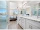 Modern bathroom features dual sinks, white cabinets, marble countertops, and a glass shower at 1500 E Laguna St, Pahrump, NV 89048