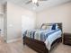 This bedroom offers wood-look floors, closet with sliding doors, and a ceiling fan at 1500 E Laguna St, Pahrump, NV 89048