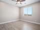 This light-filled bedroom has wood-look flooring, base trim, and a window for ample light at 1500 E Laguna St, Pahrump, NV 89048