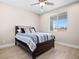 Cozy bedroom features a ceiling fan, wood-look flooring, and a sunny window view at 1500 E Laguna St, Pahrump, NV 89048