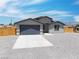 Beautiful single-story home with a two-car garage and drought tolerant landscaping in a rural area at 1500 E Laguna St, Pahrump, NV 89048
