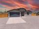 Charming single-story home featuring a two-car garage, gravel landscaping, and inviting neutral-toned exterior at 1500 E Laguna St, Pahrump, NV 89048